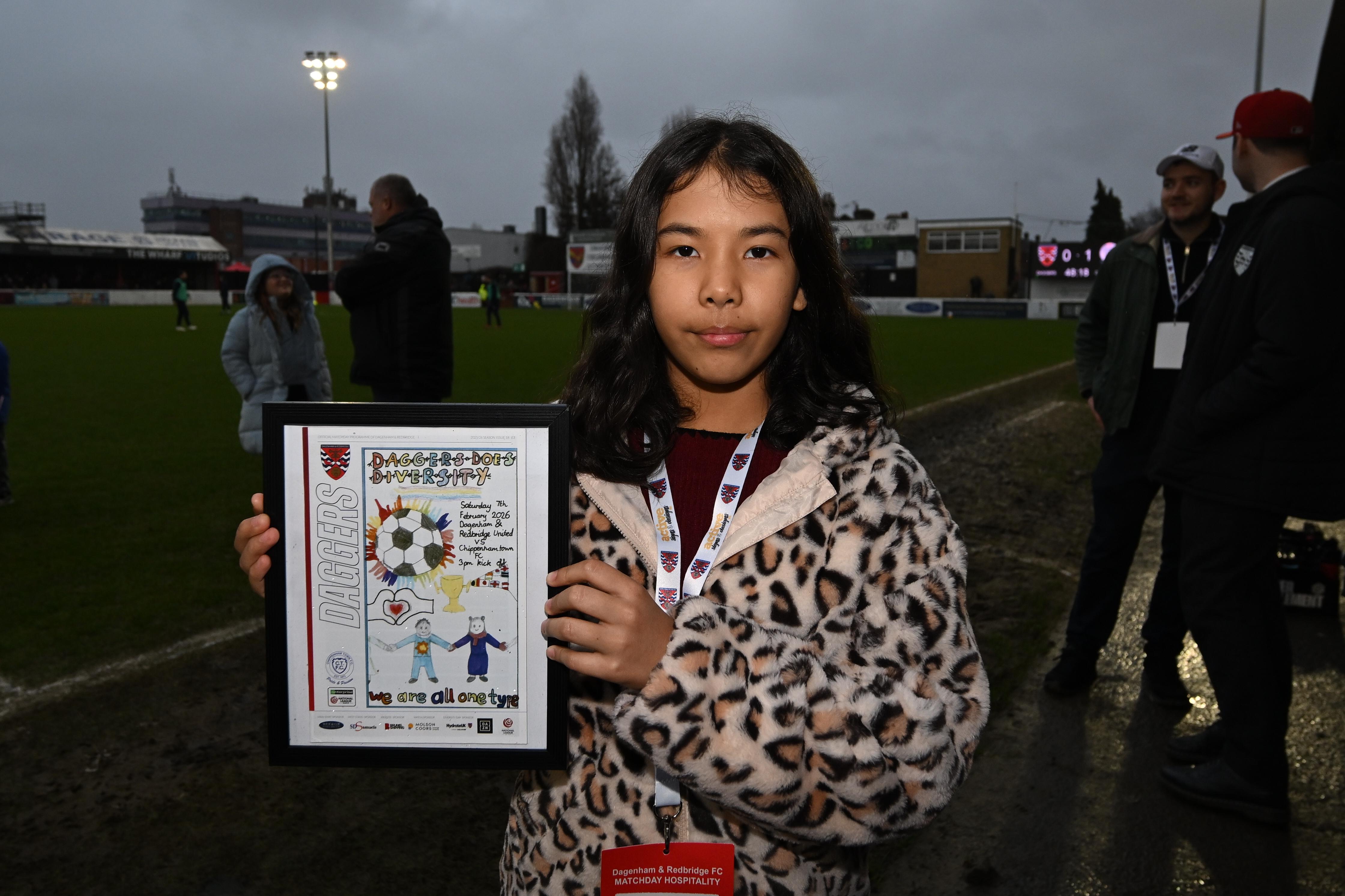 Tabisum holds her framed design